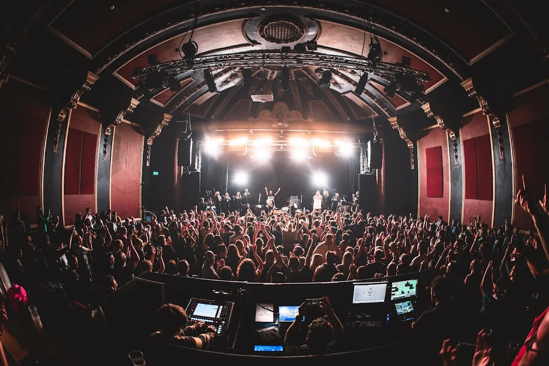 The interior of Komedia Bath during a live show, with the audience seated at tables enjoying the performance.