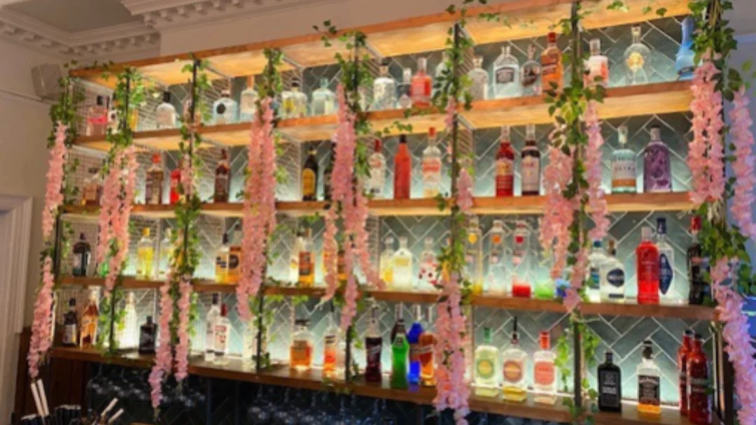 A group of friends enjoying a bottomless brunch with cocktails at a vibrant Slug & Lettuce bar.