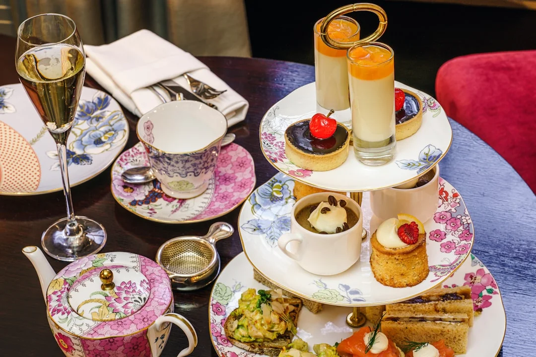 Luxurious afternoon tea in Bath: champagne, tiered stand with cakes, tarts, sandwiches, and floral china