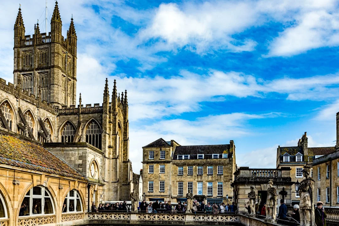 Historic Bath Abbey and surrounding Georgian architecture with people on a sunny day in Bath